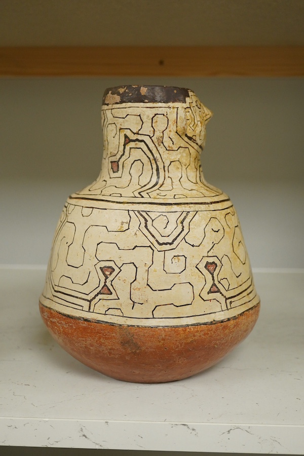 A 20th century Shipibo terracotta geometric decorated figural vase. Condition - minor paint chips